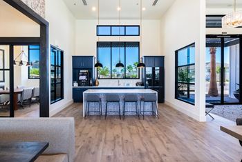 a living room with a kitchen and a large window